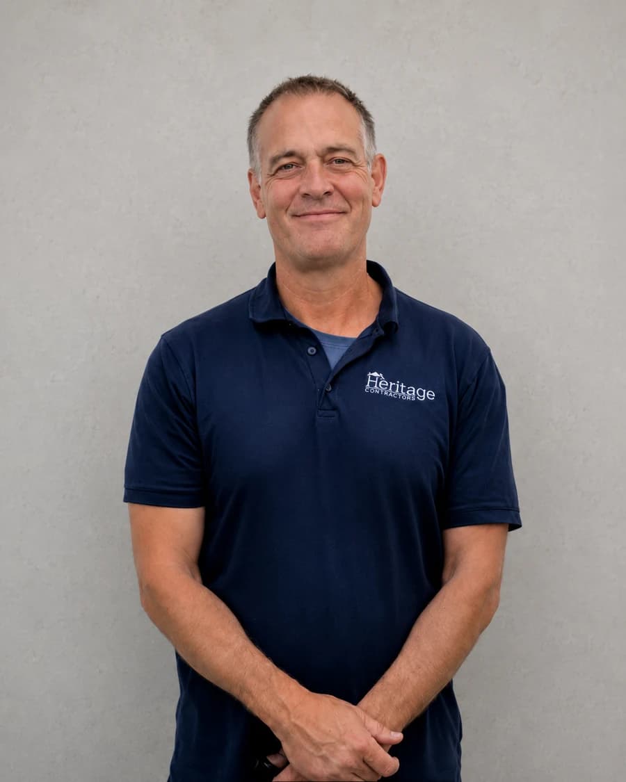 John P., Owner and Vice President of Heritage Contractors, in a navy polo shirt