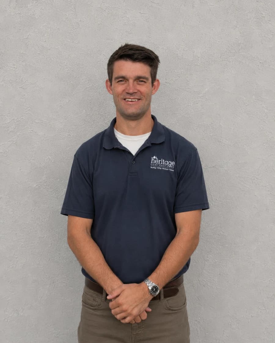 Charlie P., Vice President of Sales at Heritage Contractors, in a navy polo with a white undershirt
