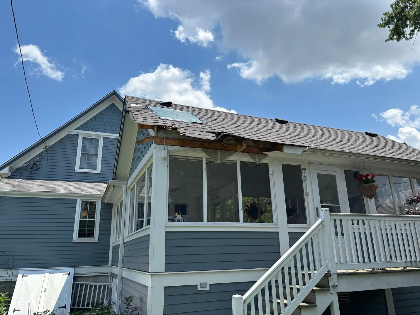 Storm-damaged roof and exterior before restoration by Heritage Contractors